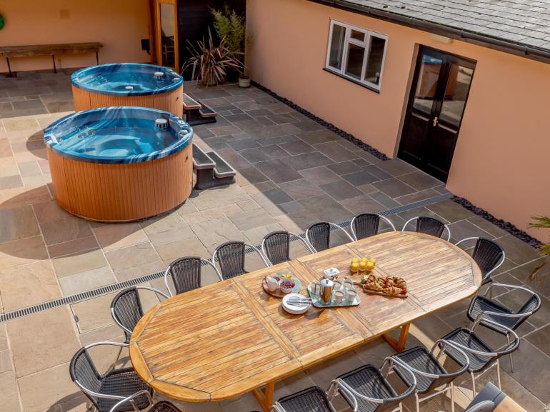 Sutton Barton Farmhouse - large table for al fresco dining and 2 hot tubs